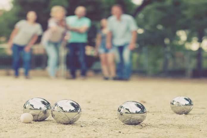 Portrait of friendly people playing petanque at leisure